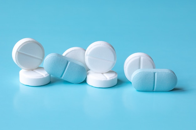 White and blue tablets or pills or medication or drugs