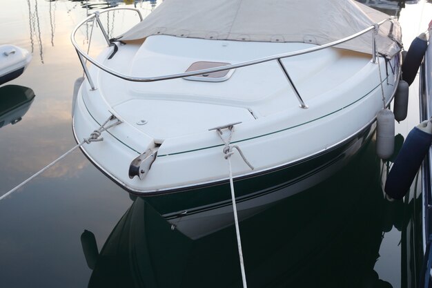 White and blue yacht mooring in the bay