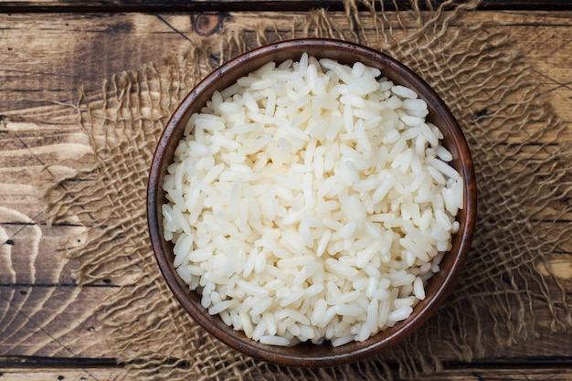 White boiled rice in a wooden bowl. Rustic style.