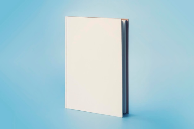 A white book on a blue background Empty space on cover for design and text