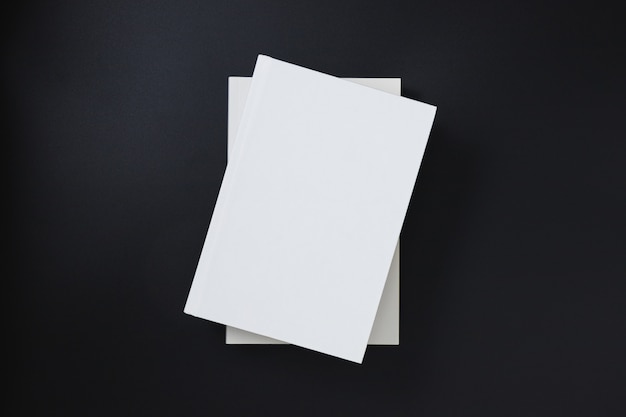 Photo white book covers stacked on a black background