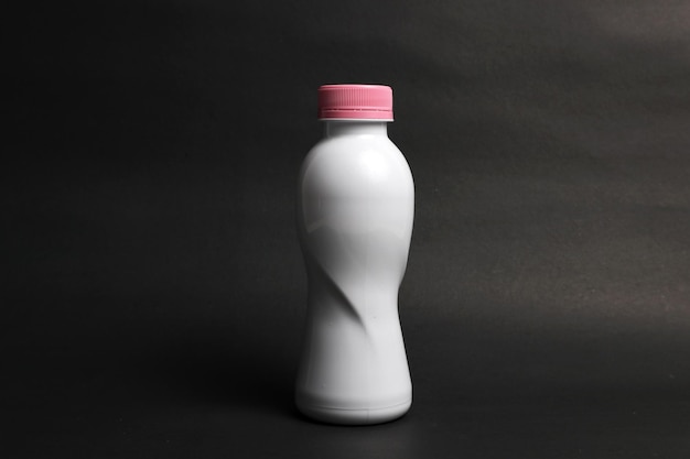 Photo white bottle mockup with black background