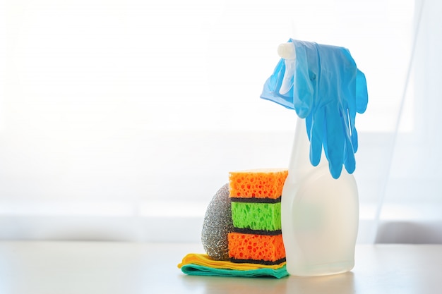 White bottle spray cleaner and clean sponge on a table.