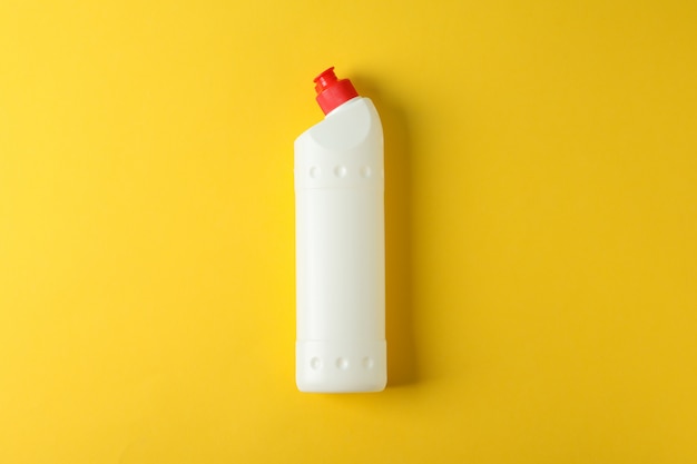 White bottle with detergent on yellow