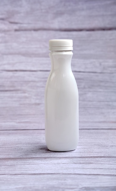 White bottle with a lid on a wooden