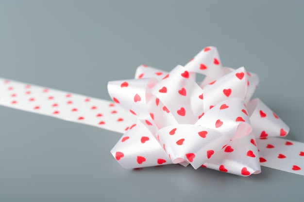 White bow and ribbon with hearts