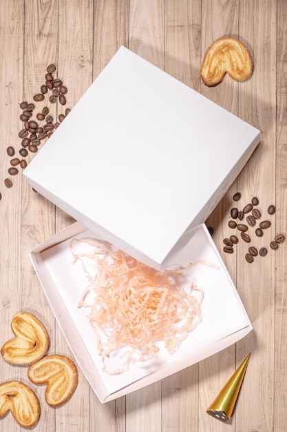 Photo white box mockup between different sweets on the table and figures