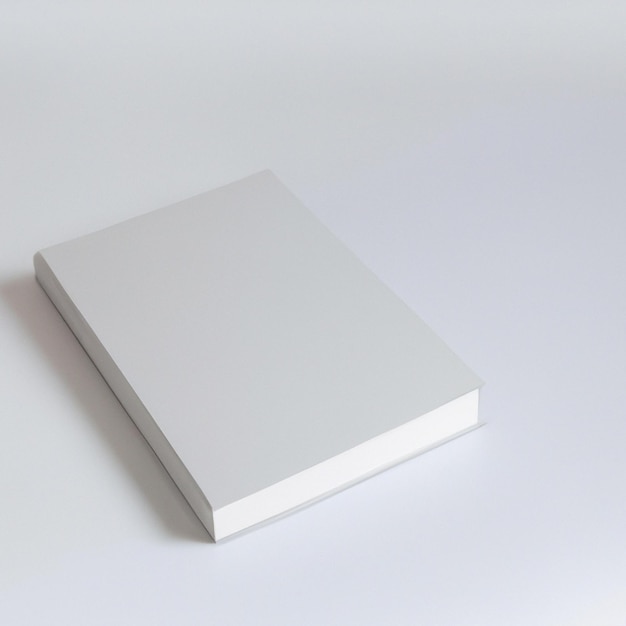 A white box with a white cover is on a white surface.