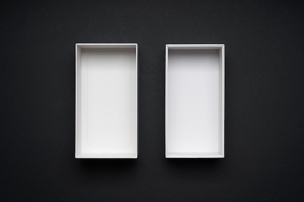Photo white boxes opened mockup display on black background. top view