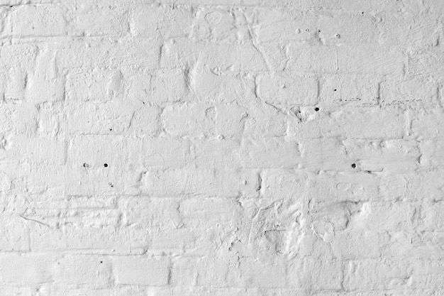 Белая предпосылка или текстура кирпичной стены.