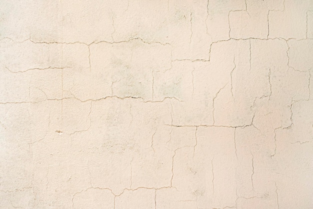 White brick wall with small cracks