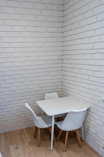 White brick wall with table in corner of kitchen