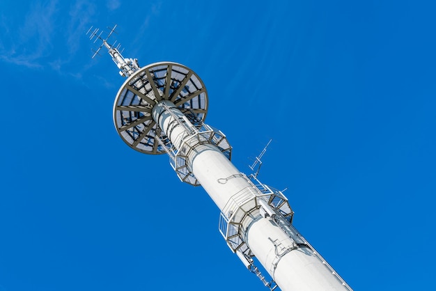 White broadcasting tower against the blue sky