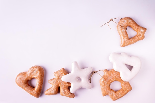 White and brown gingerbread cookies on white background with copy space