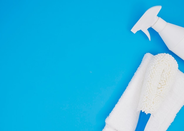 White brush; napkin and bottle on blue backdrop