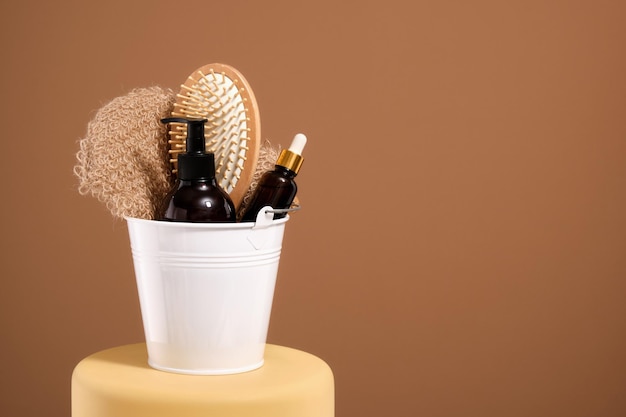 A white bucket of hygiene accessories in home bathroom Bodycare concept Copy space for text