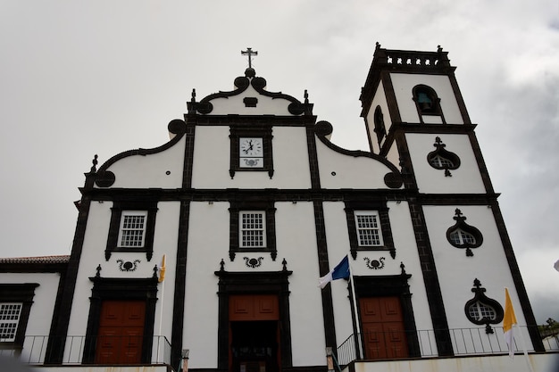 a white building with a black and white clock on the front