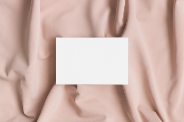 white business card mockup on a beige textile 85x55mm