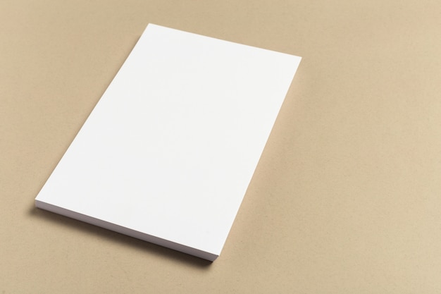 White business card on wooden table. Blank portrait A4.