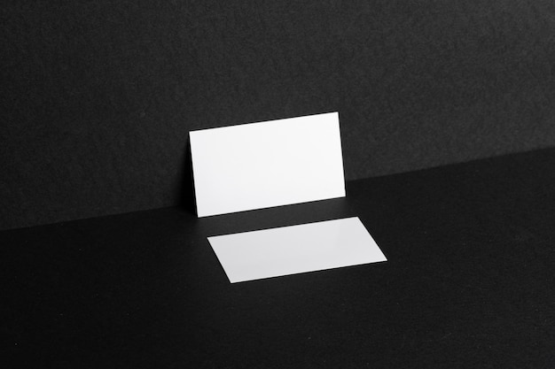 White businesscards on black background close up, copy space