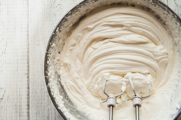 White butter cream in a metal bowl