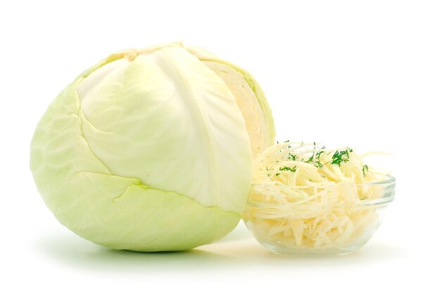 White cabbage and bowl of chopped cabbage isolated on white background