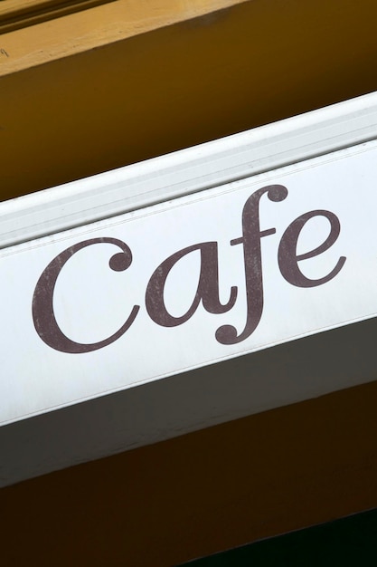 Photo white cafe sign on building facade