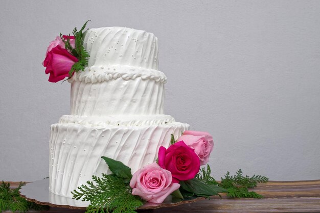 White cake decorated with roses Three tier cake