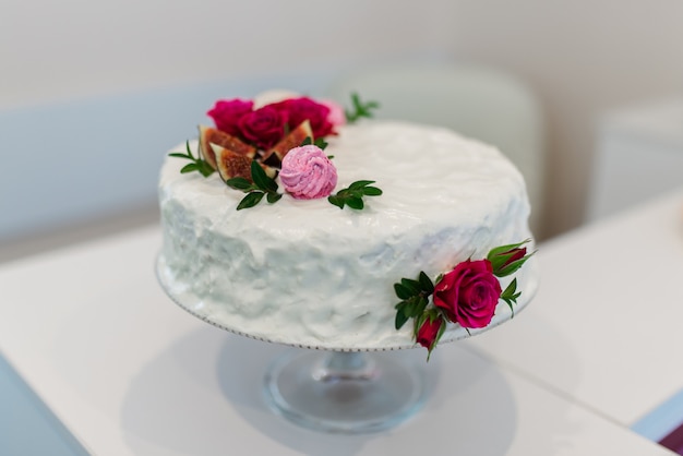 White cake with red flowers. white background