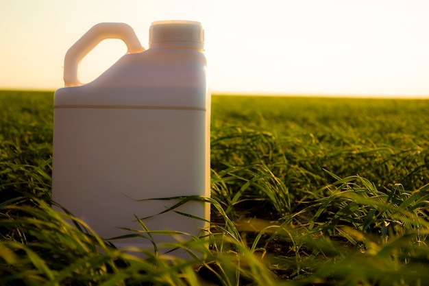 white canister against the background of agriculture canisters from under different types of chemic