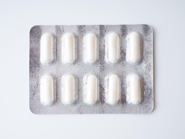 White capsules or pills in a grey blister pack Closeup