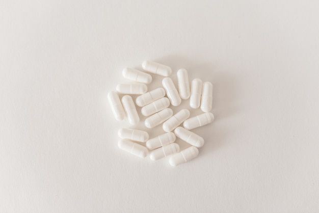 White capsules on a white table