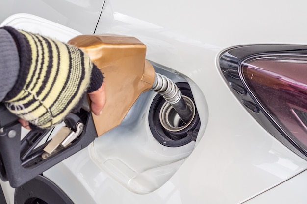 White car refueling at petrol gas station