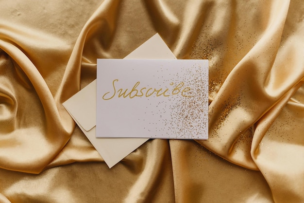 white card on gold textile stock photo