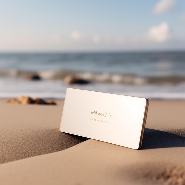 a white card on the sand with the ocean in the background.