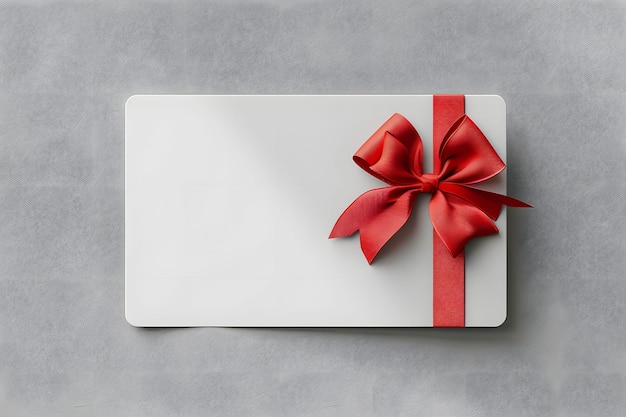 Photo a white card with a red bow on it with a red ribbon