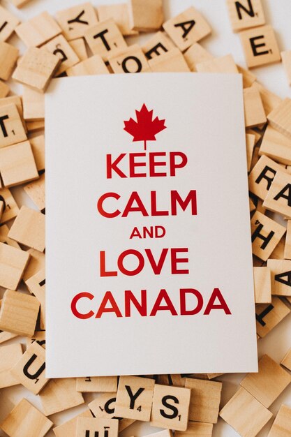 A white card with the words keep calm and love canada on it