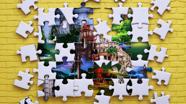 White cardboard jigsaw puzzles on yellow background