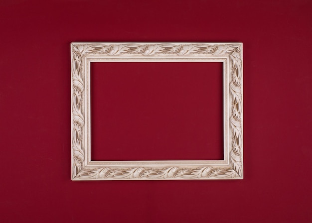 Photo white carved frame isolated on red background