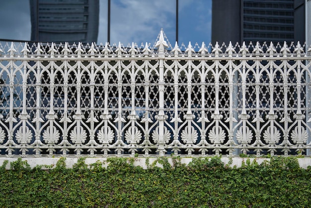 White castiron fence with patterns fragment close up