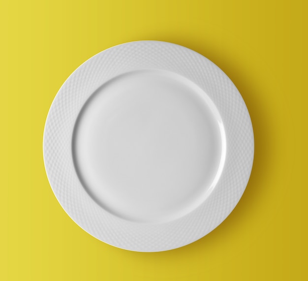 White ceramic plate on yellow background