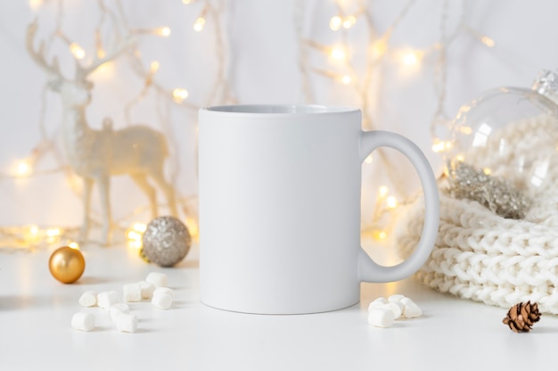 White ceramic tea mug mockup with winter xmas decorations and copy space for your design front view