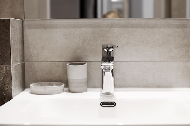 White ceramic washbasin, glossy metal faucet