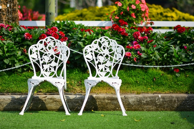 White chair in the flowers garden.