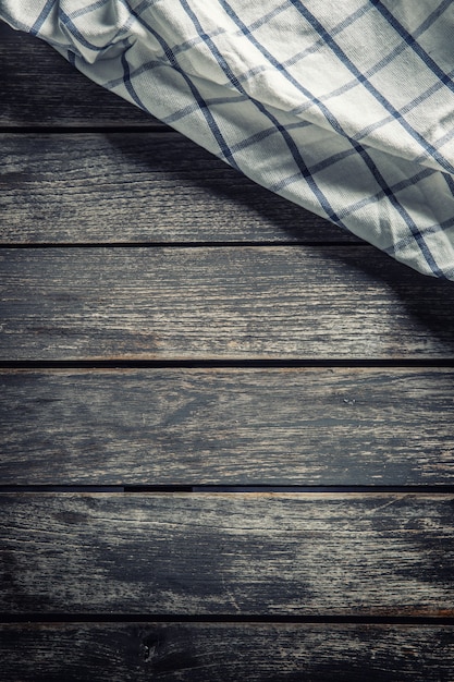 White checkered tablecloth on dark wooden table.