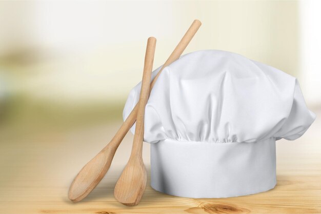 White chef hat and kitchen utensils