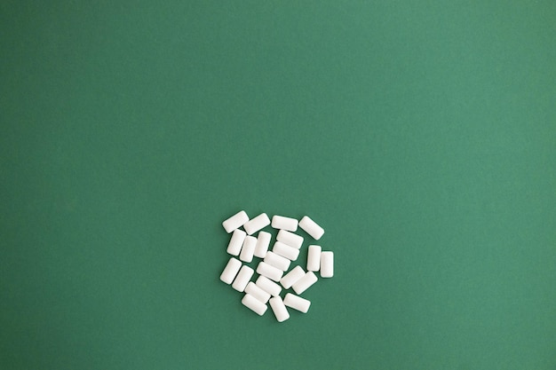 White chewing gum on green background