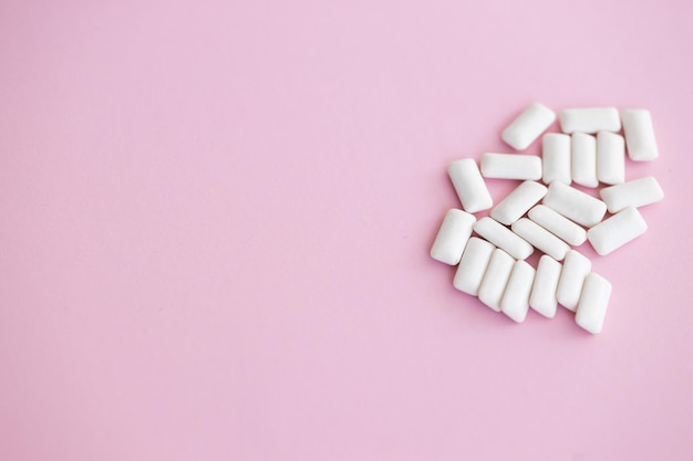 White chewing gum on pink background