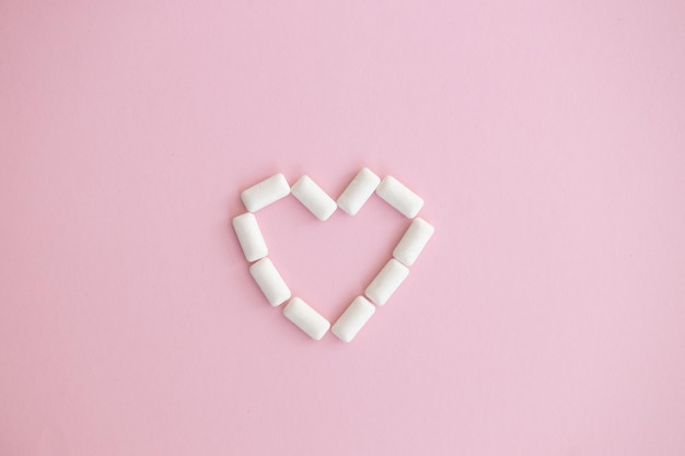 White chewing gum on pink background