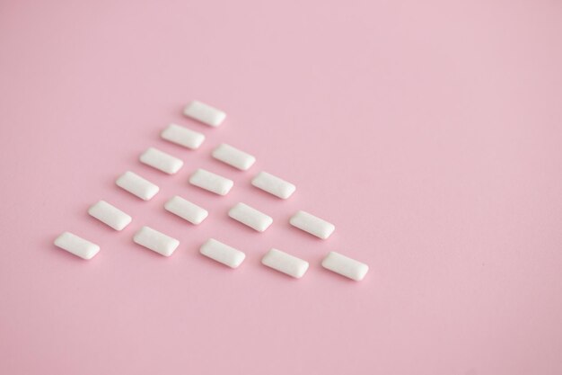 White chewing gum on pink background